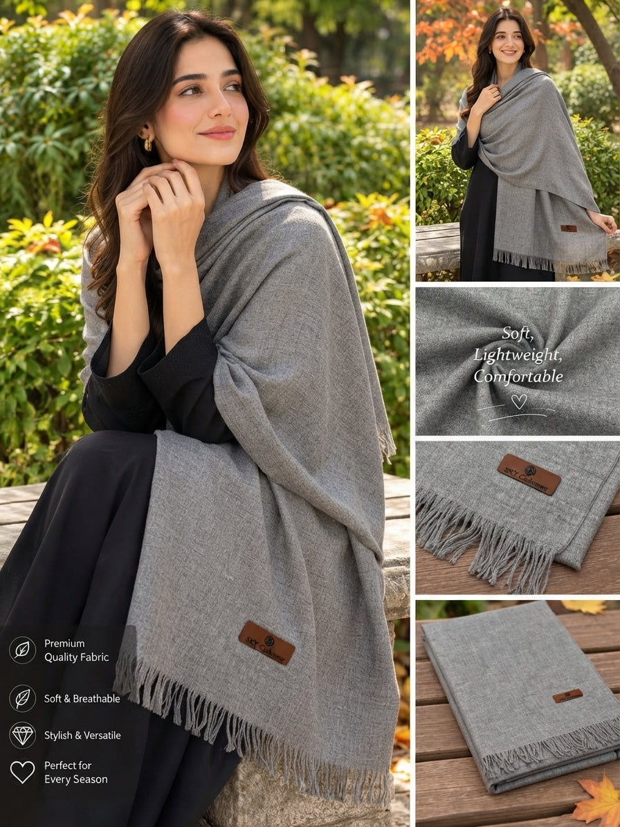A woman modeling a light gray shawl in an outdoor garden setting, with a vertical collage showing additional views of the shawl draped on her, folded, and close-up fabric details. The shawl has a small brown leather brand patch and fringe edges.